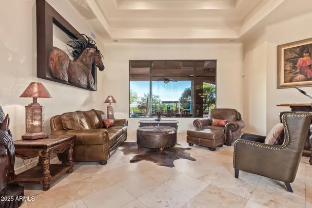 a living room with furniture and a chandelier