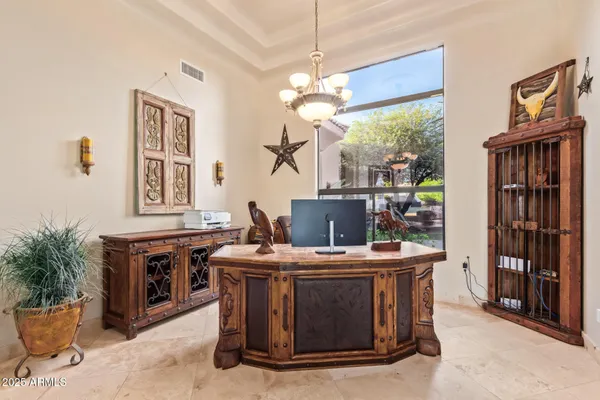 a living room with furniture kitchen view and a chandelier