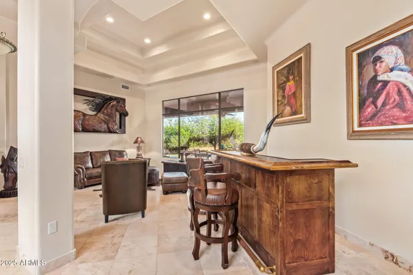 a living room with patio furniture and a large window
