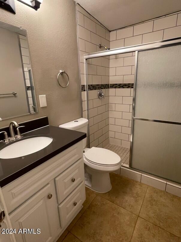 3111 North 34th Street Phoenix, AZ 85018 - Photo 13 of 15 a bathroom with a granite countertop toilet sink and shower
