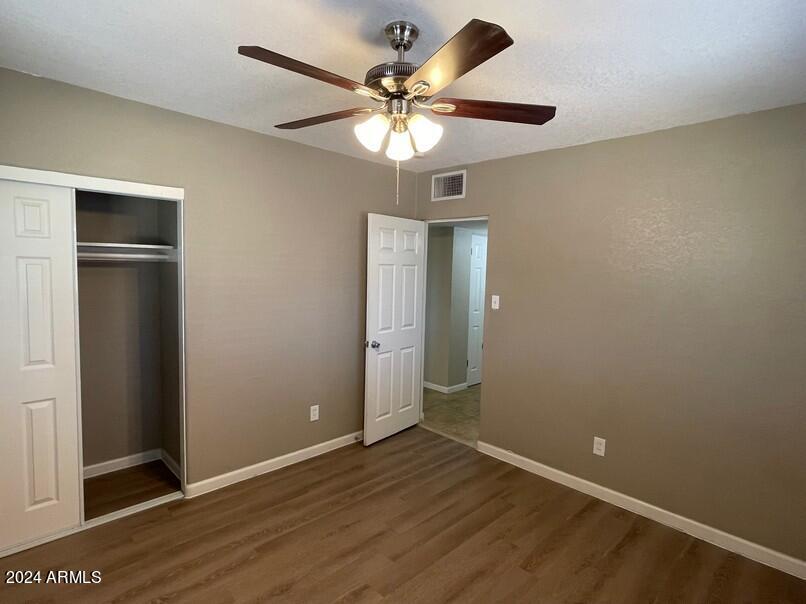 3111 North 34th Street Phoenix, AZ 85018 - Photo 7 of 15 an empty room with wooden floor closet and windows