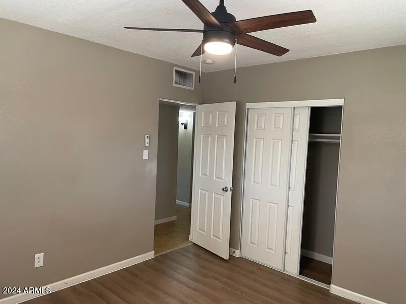 3111 North 34th Street Phoenix, AZ 85018 - Photo 9 of 15 an empty room with wooden floor closet and windows