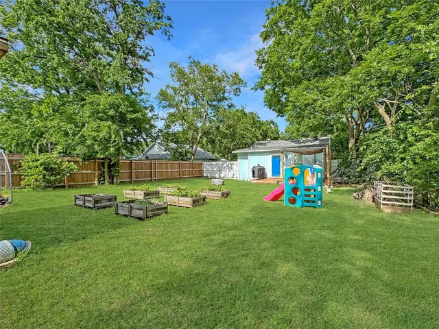 a view of yard with swimming pool and green space