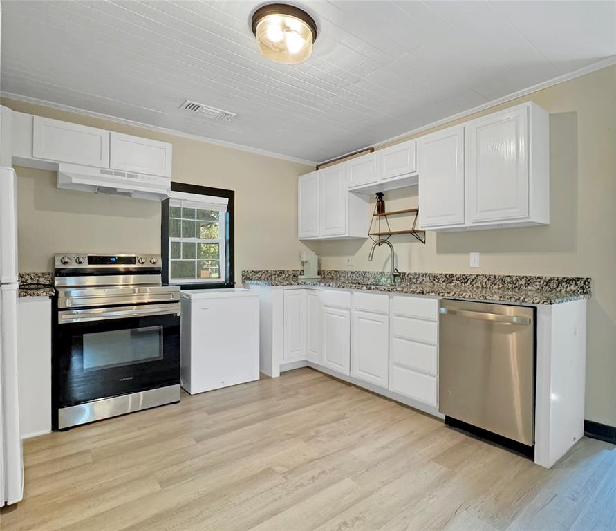 604 Maple Street Howe, TX 75459 - Photo 4 of 16 a kitchen with granite countertop a stove top oven sink and cabinets