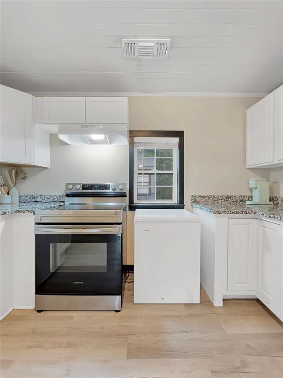 604 Maple Street Howe, TX 75459 - Photo 6 of 16 a kitchen with granite countertop a stove top oven a sink and cabinets