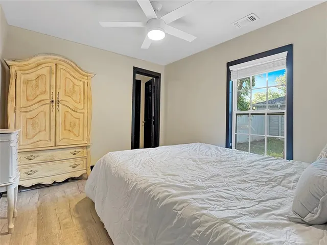 a bedroom with a bed dresser and a window