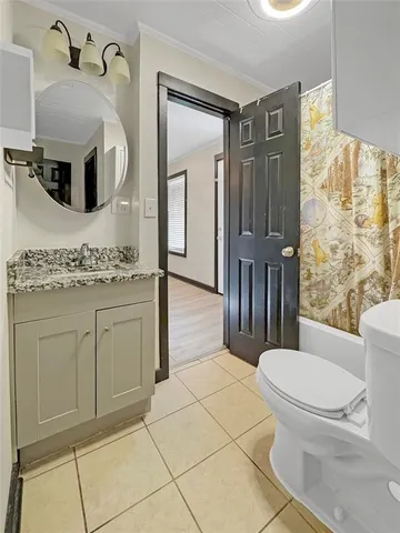 a bathroom with a toilet a sink and a mirror