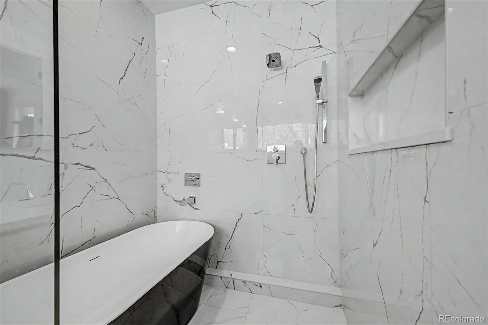 8 South Colorado Boulevard Denver, CO 80246 - Photo 14 of 40 a bathroom with a bathtub and shower