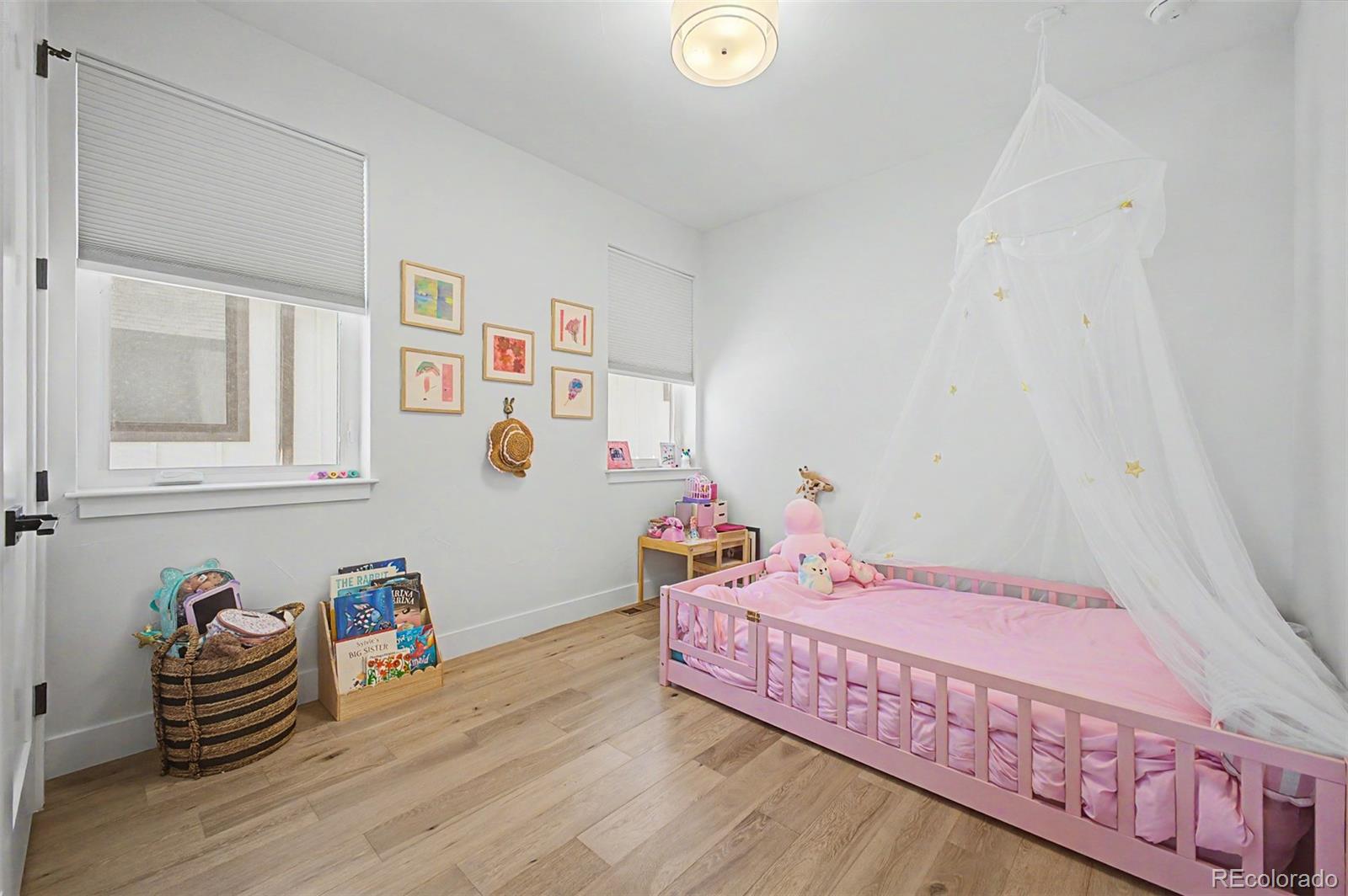 8 South Colorado Boulevard Denver, CO 80246 - Photo 18 of 40 a bedroom with bed and wooden floor