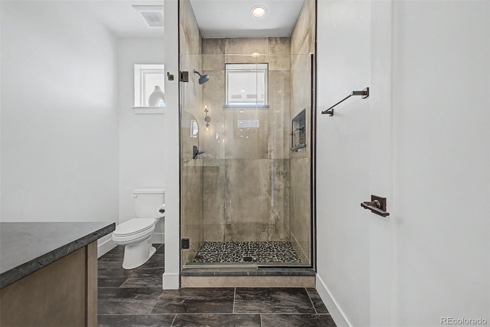 8 South Colorado Boulevard Denver, CO 80246 - Photo 21 of 40 a bathroom with a shower and toilet