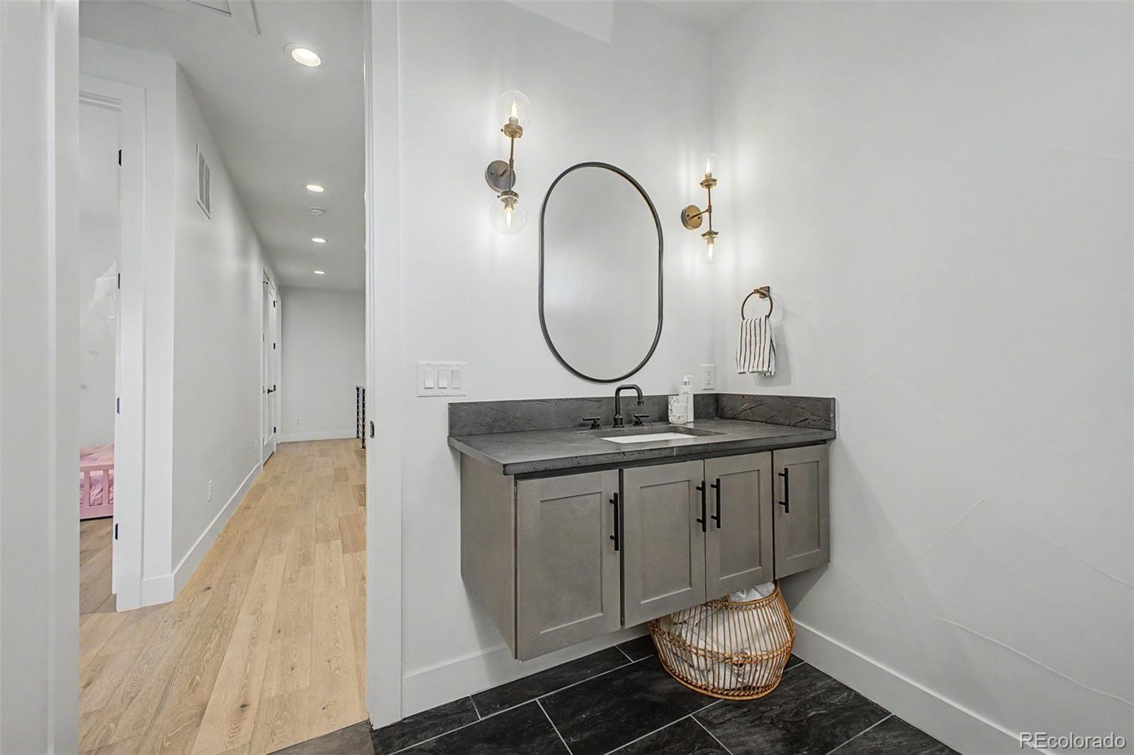8 South Colorado Boulevard Denver, CO 80246 - Photo 22 of 40 a bathroom with a sink and a mirror