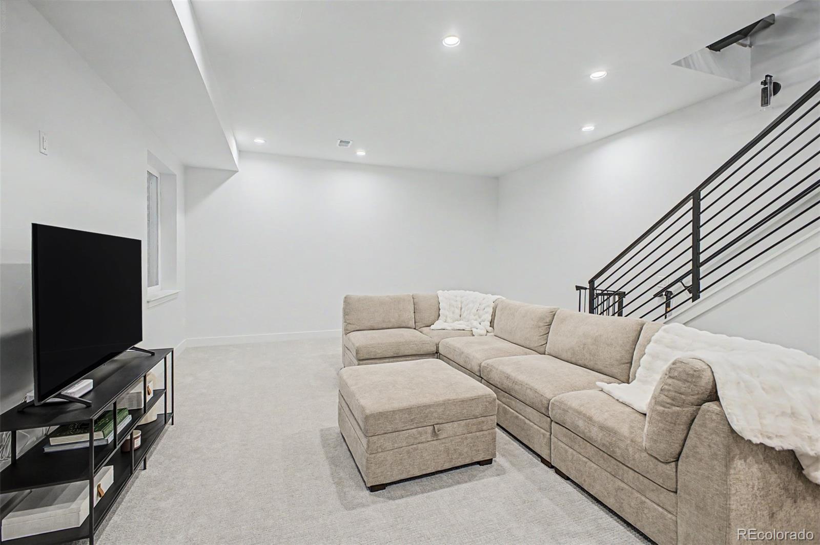 8 South Colorado Boulevard Denver, CO 80246 - Photo 25 of 40 a living room with furniture and a flat screen tv