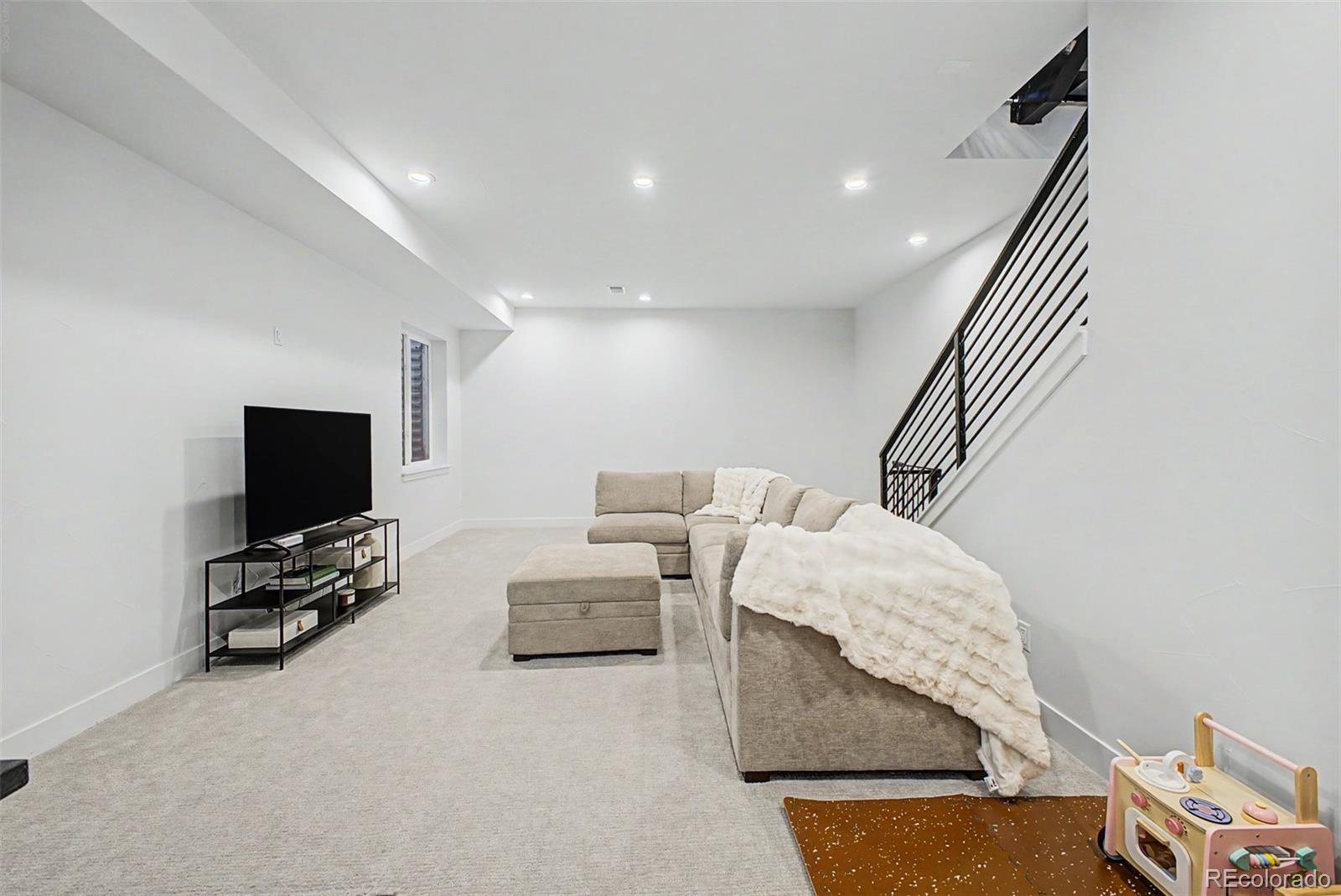8 South Colorado Boulevard Denver, CO 80246 - Photo 26 of 40 a living room with furniture and a flat screen tv