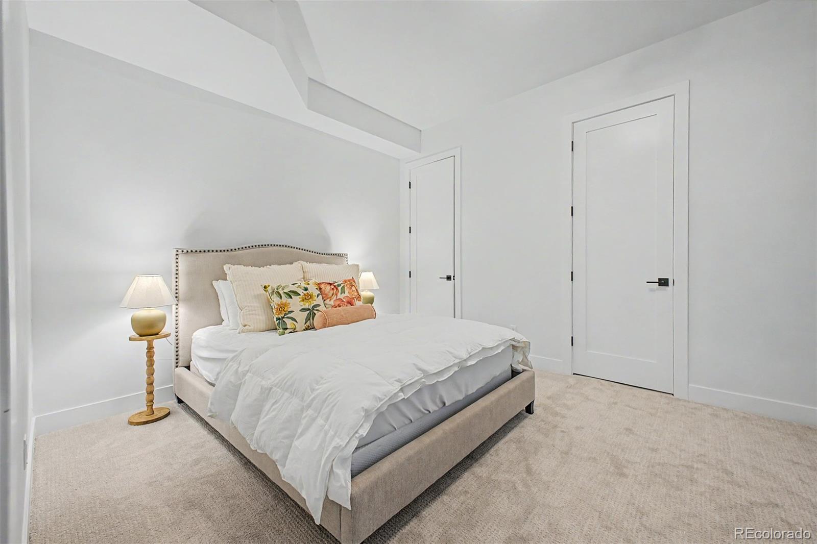 8 South Colorado Boulevard Denver, CO 80246 - Photo 27 of 40 a bedroom with a bed and a lamp
