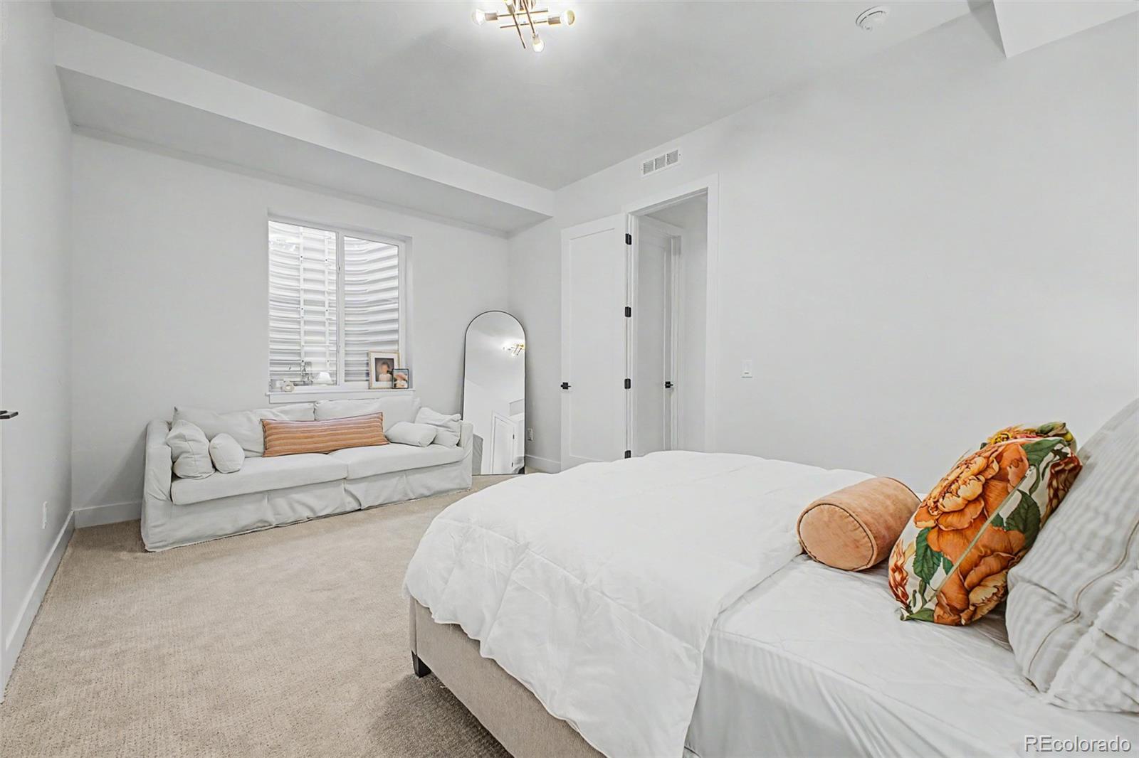 8 South Colorado Boulevard Denver, CO 80246 - Photo 29 of 40 a bedroom with a bed couch and window