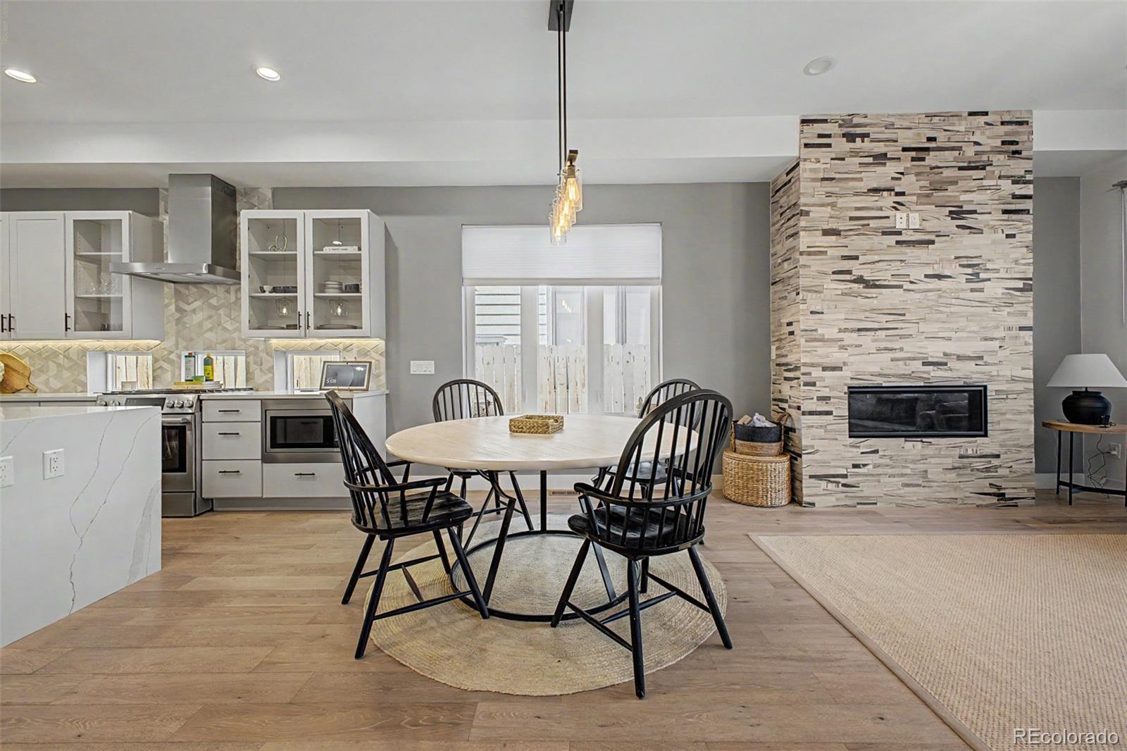 8 South Colorado Boulevard Denver, CO 80246 - Photo 6 of 40 a dining room with furniture a chandelier and wooden floor