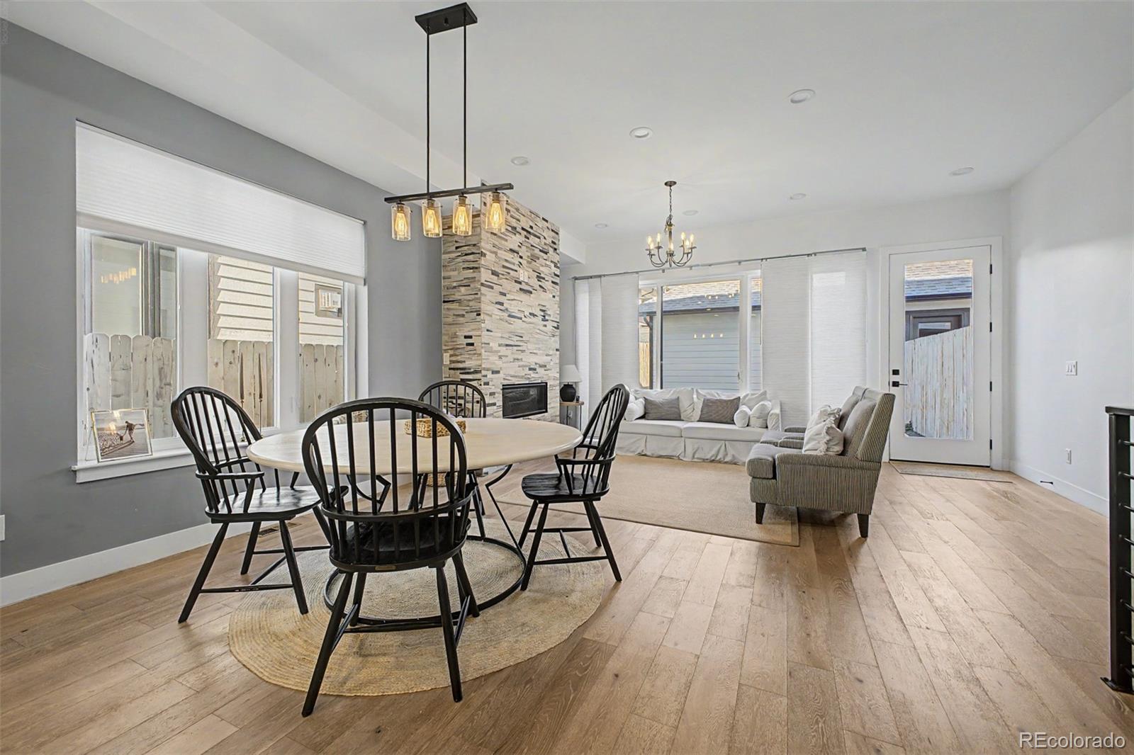 8 South Colorado Boulevard Denver, CO 80246 - Photo 7 of 40 a dining room with furniture a chandelier and wooden floor