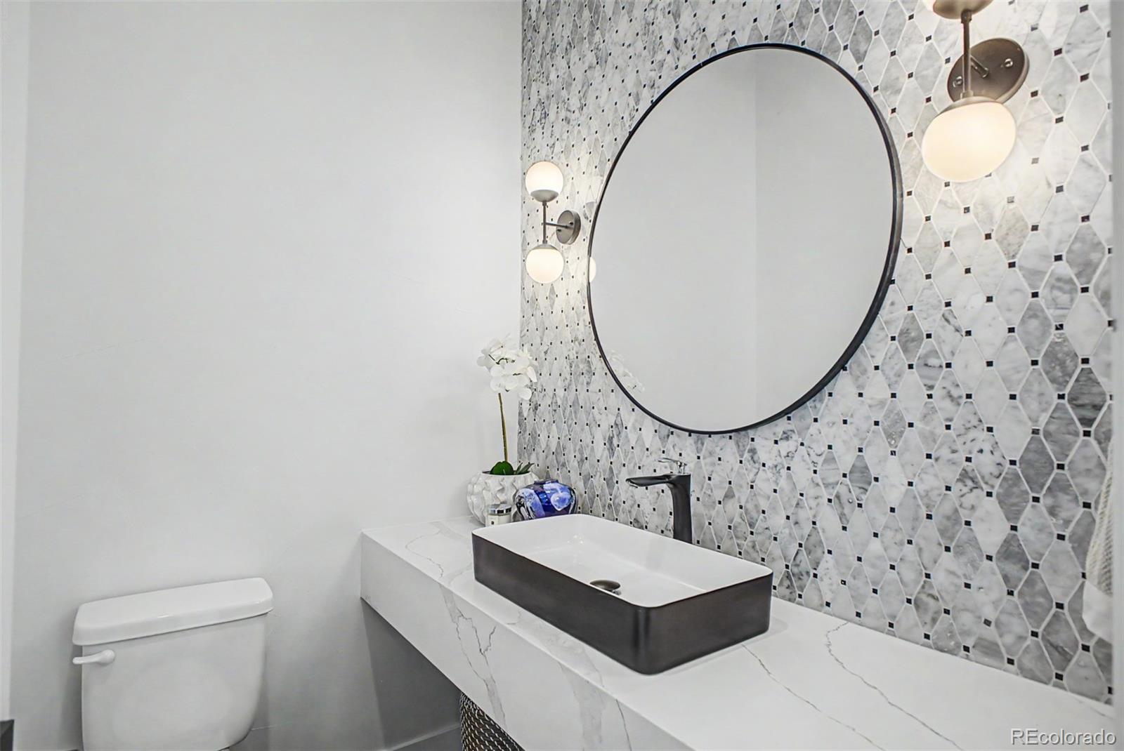 8 South Colorado Boulevard Denver, CO 80246 - Photo 8 of 40 a bathroom with a sink a toilet and a mirror