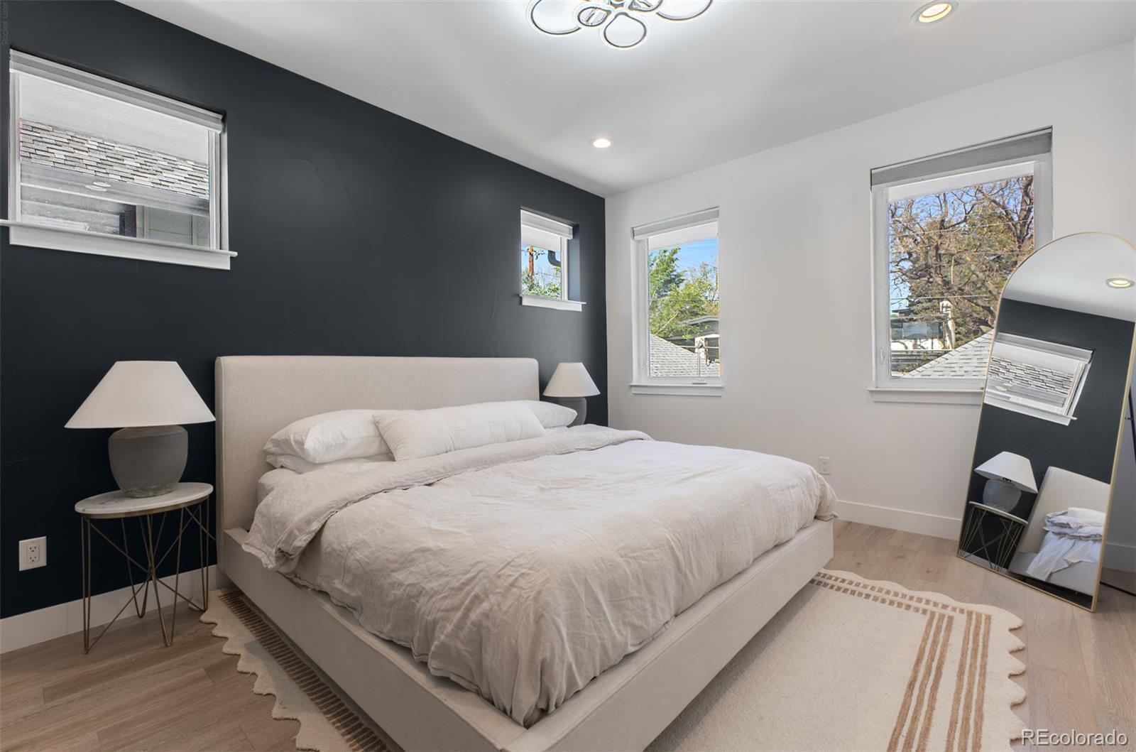 8 South Colorado Boulevard Denver, CO 80246 - Photo 10 of 40 a bedroom with a bed and a lamp
