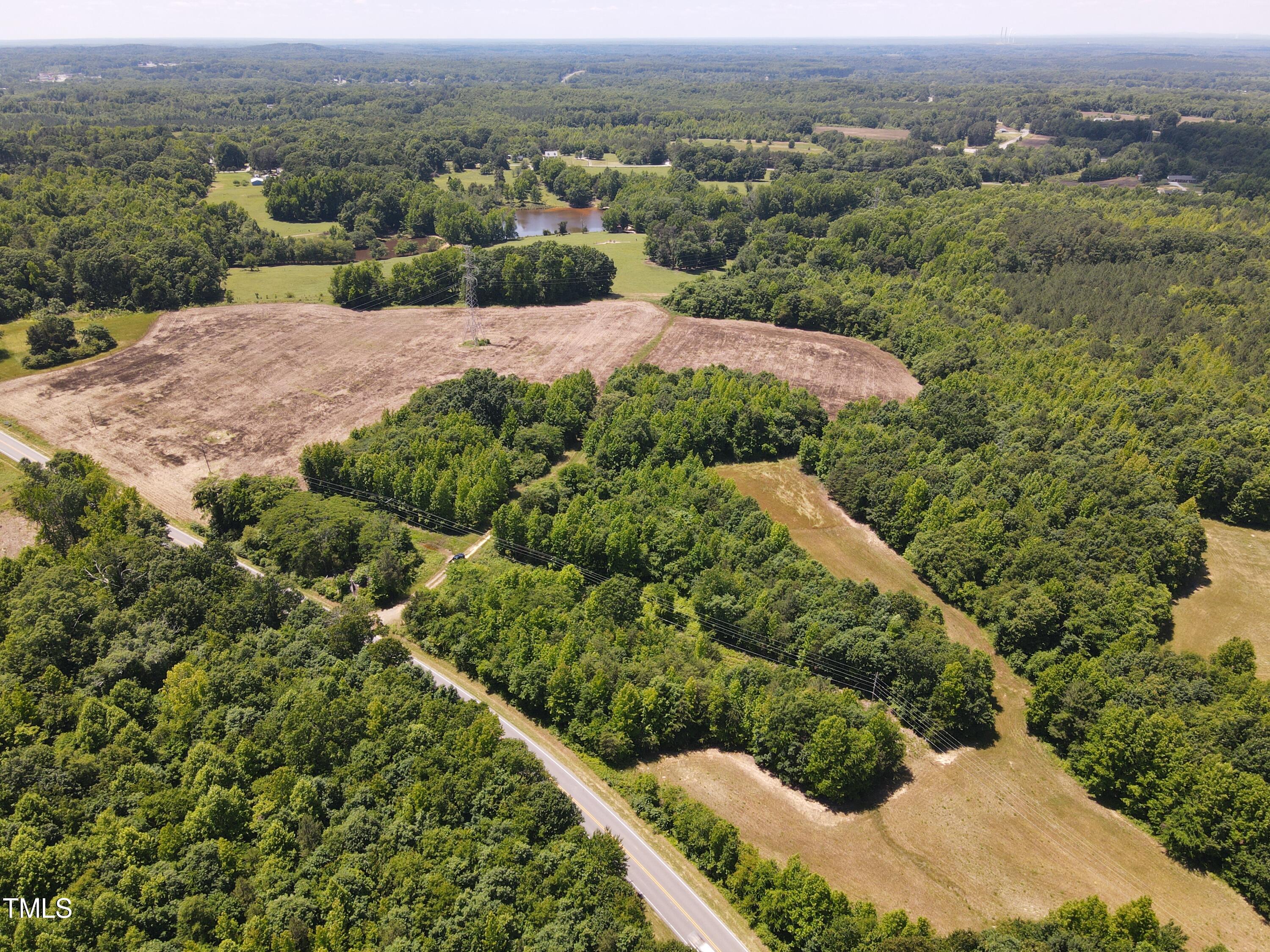 0 Virgilina Road Roxboro, NC 27574 - Photo 24 of 27 an aerial view of green landscape with trees houses and mountain view