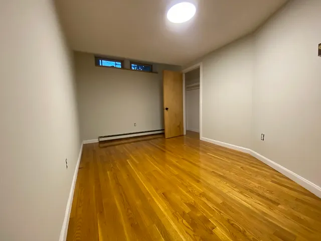 a view of a room with wooden floor and bathroom