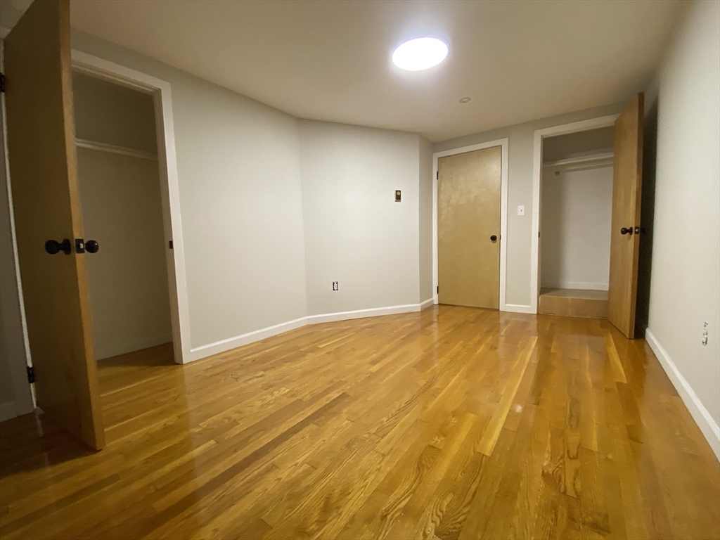 90 Bynner Street, Unit B Boston, MA 02130 - Photo 12 of 15 a view of a room with wooden floor and bathroom