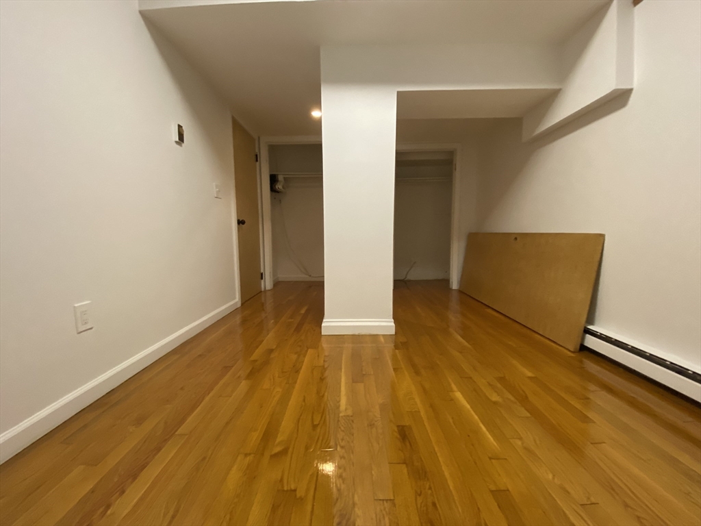 90 Bynner Street, Unit B Boston, MA 02130 - Photo 6 of 15 a view of an empty room with wooden floor