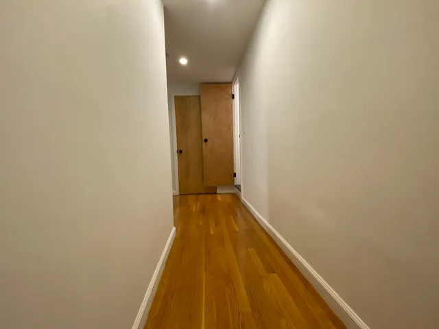 a view of a bathroom with wooden floor