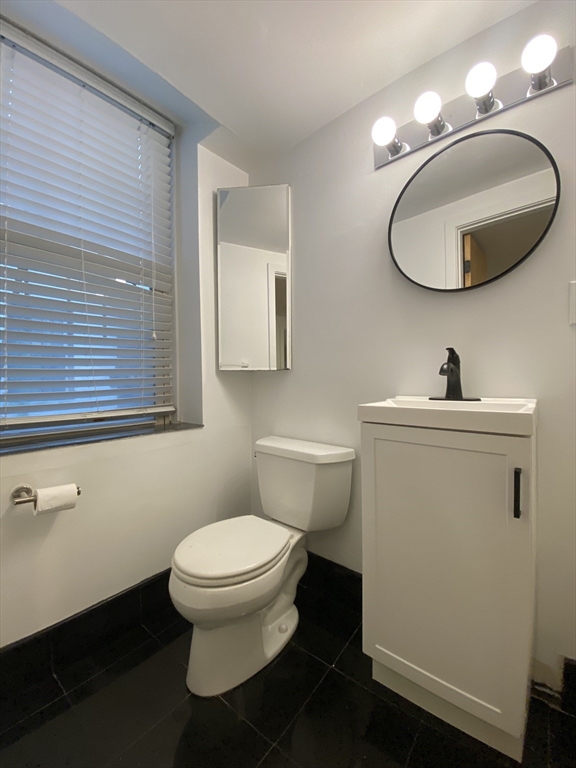 90 Bynner Street, Unit B Boston, MA 02130 - Photo 9 of 15 a bathroom with a toilet a sink and mirror