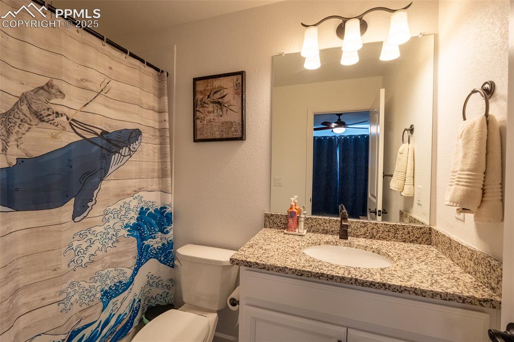 15619 Kitchener Way Monument, CO 80132 - Photo 20 of 40 a bathroom with a granite countertop sink and a mirror