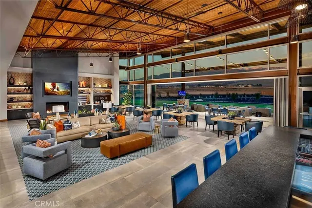 a living room with lots of furniture and kitchen view