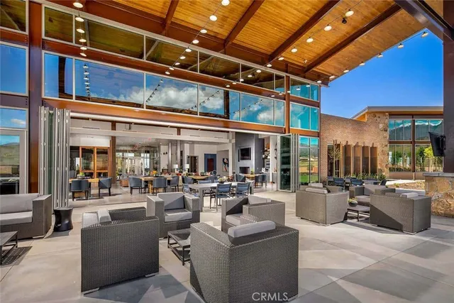 a living room with furniture and large windows