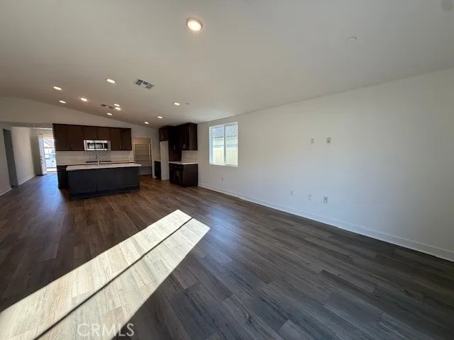 a view of kitchen with cabinets and wooden floor