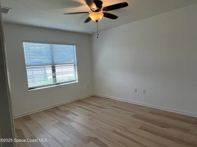 a bathroom with a granite countertop sink a mirror and a shower