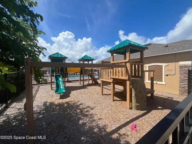 a view of a porch with furniture and a yard