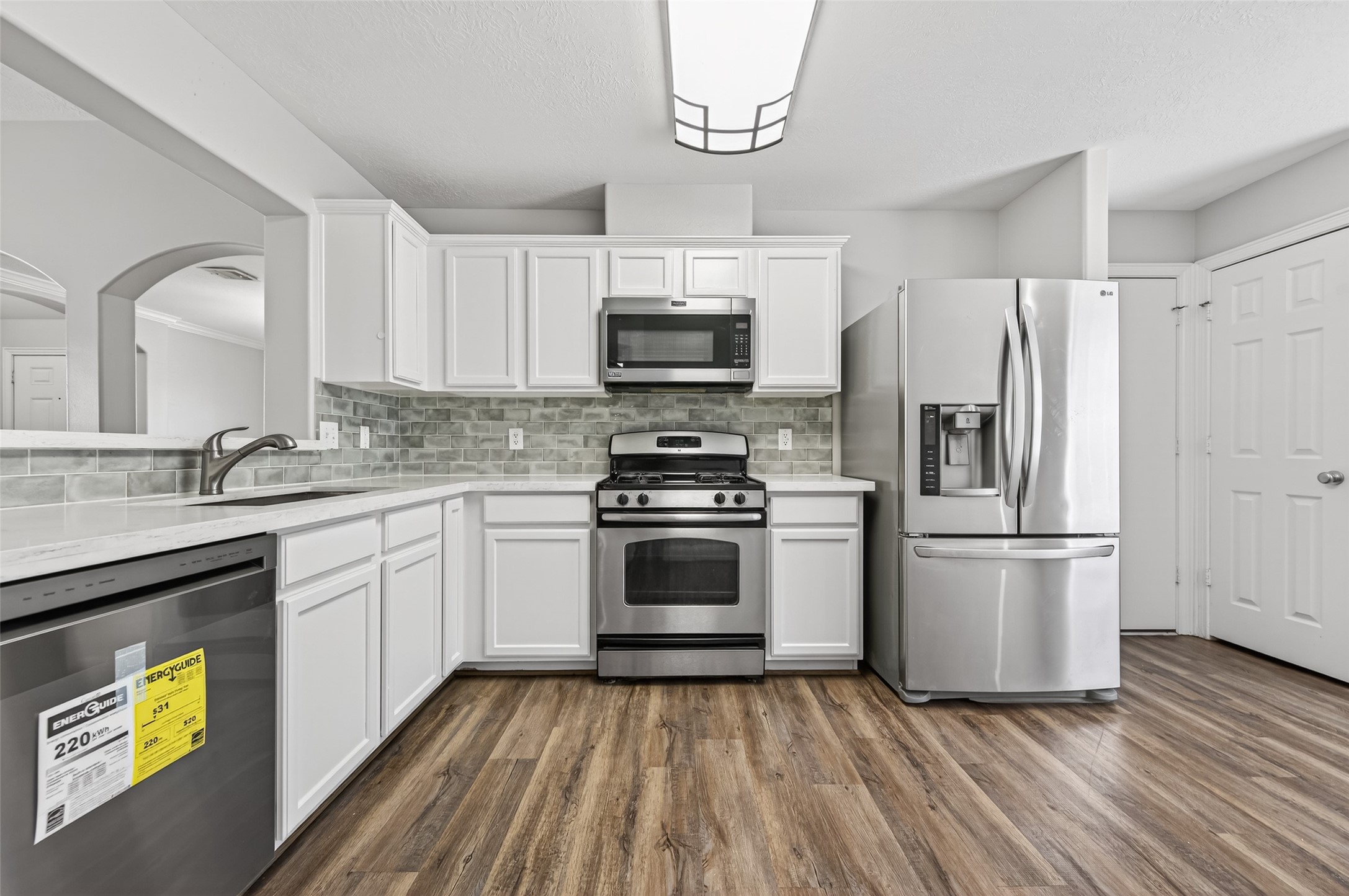 22419 Bridgestone Ridge Drive Spring, TX 77389 - Photo 11 of 48 a kitchen with a refrigerator and a sink