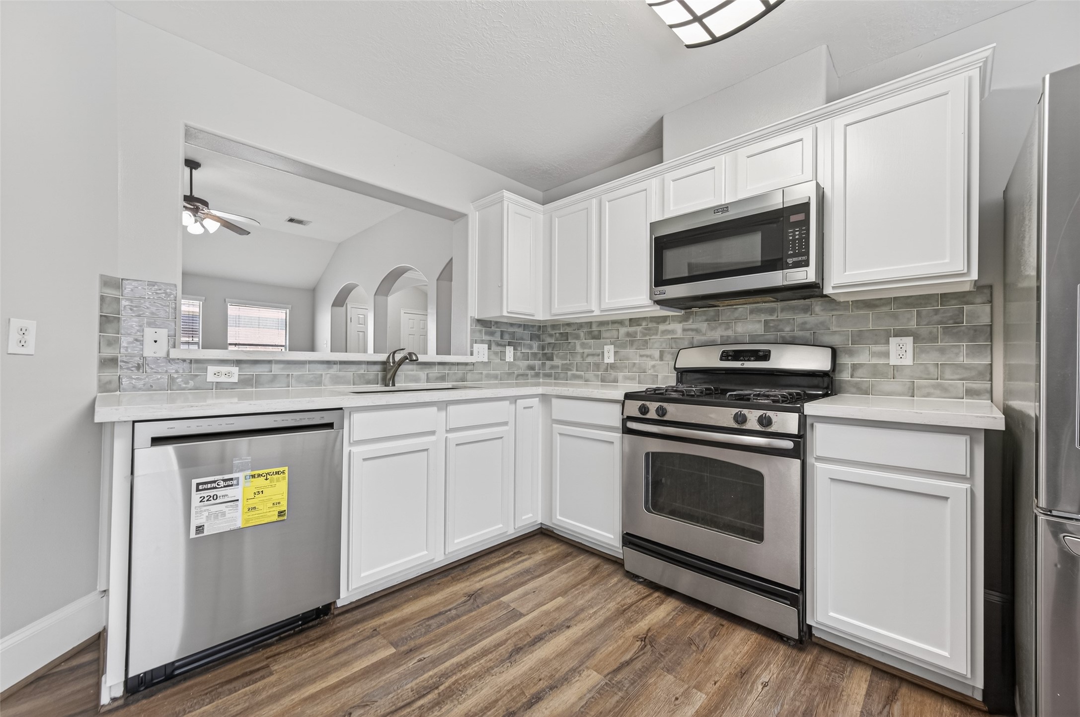 22419 Bridgestone Ridge Drive Spring, TX 77389 - Photo 12 of 48 a kitchen with stainless steel appliances granite countertop a stove microwave and sink