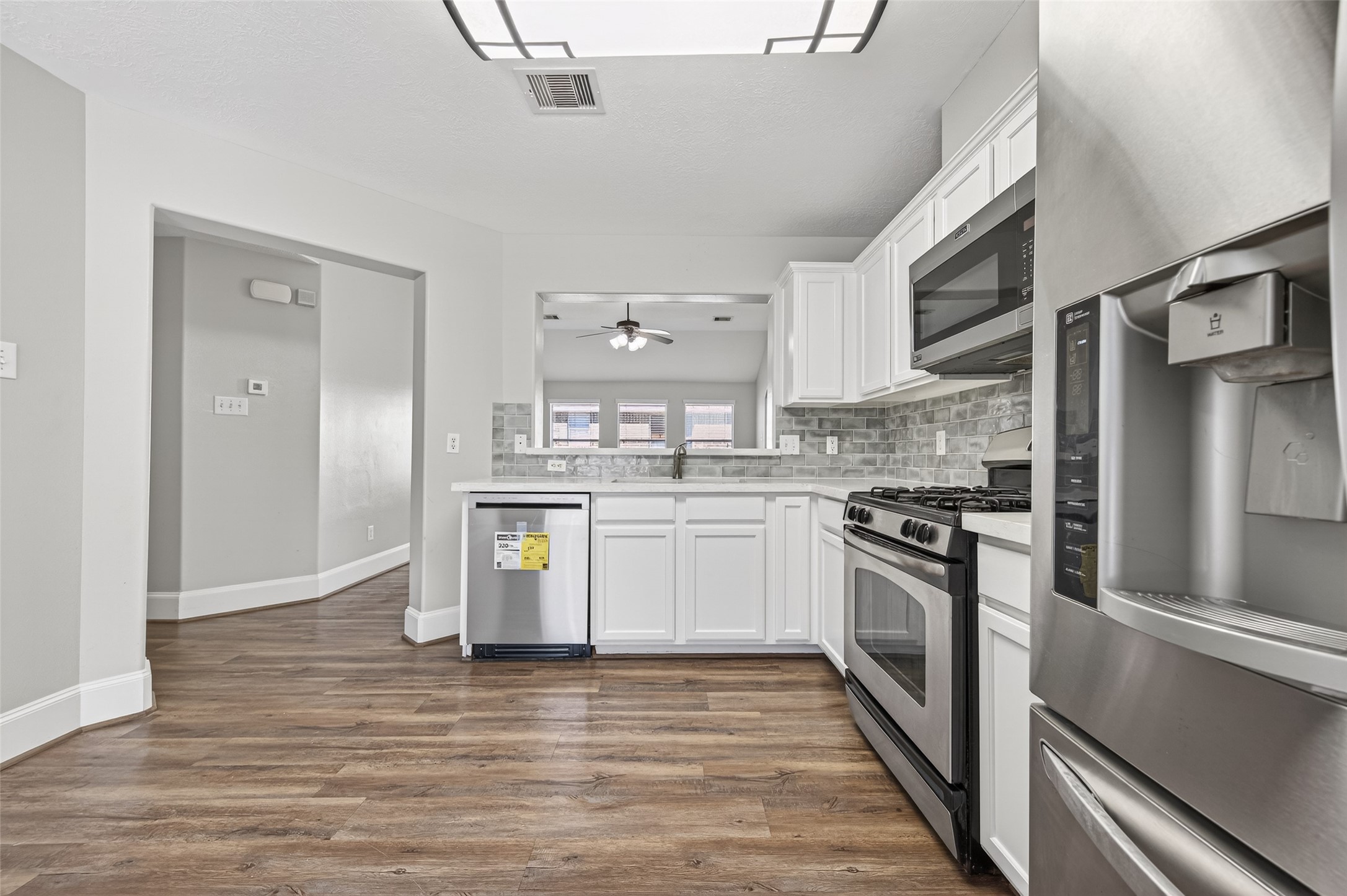 22419 Bridgestone Ridge Drive Spring, TX 77389 - Photo 13 of 48 a kitchen with stainless steel appliances granite countertop a stove and a refrigerator