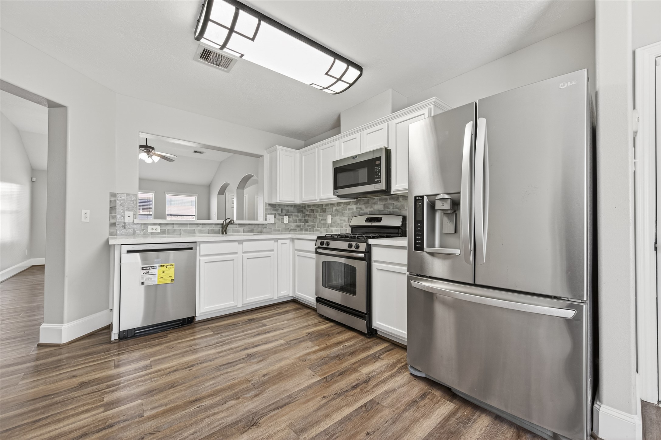22419 Bridgestone Ridge Drive Spring, TX 77389 - Photo 14 of 48 a kitchen with a refrigerator cabinets and stainless steel appliances