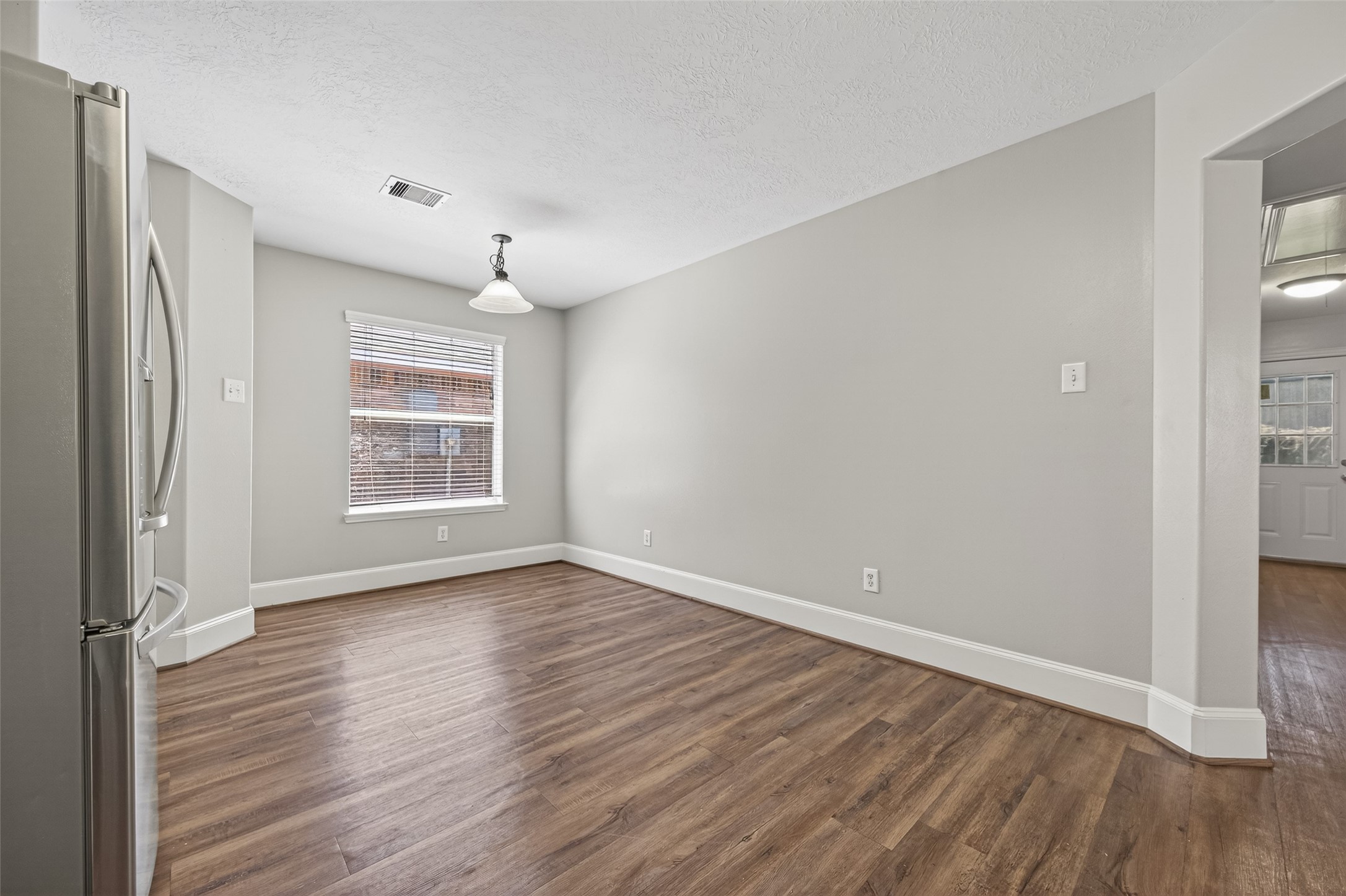 22419 Bridgestone Ridge Drive Spring, TX 77389 - Photo 15 of 48 an empty room with wooden floor cabinet and windows