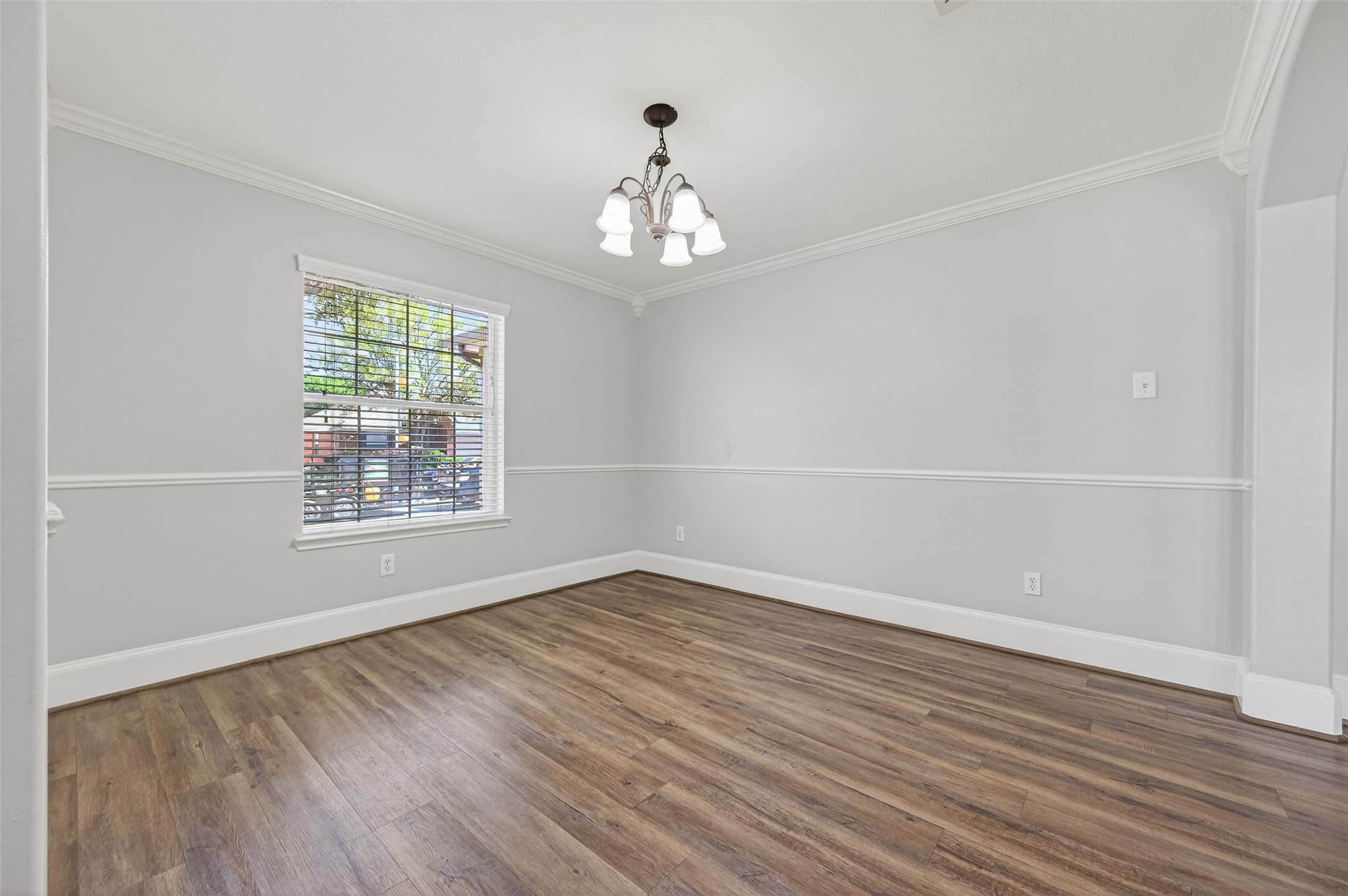 22419 Bridgestone Ridge Drive Spring, TX 77389 - Photo 17 of 48 an empty room with wooden floor chandelier and windows