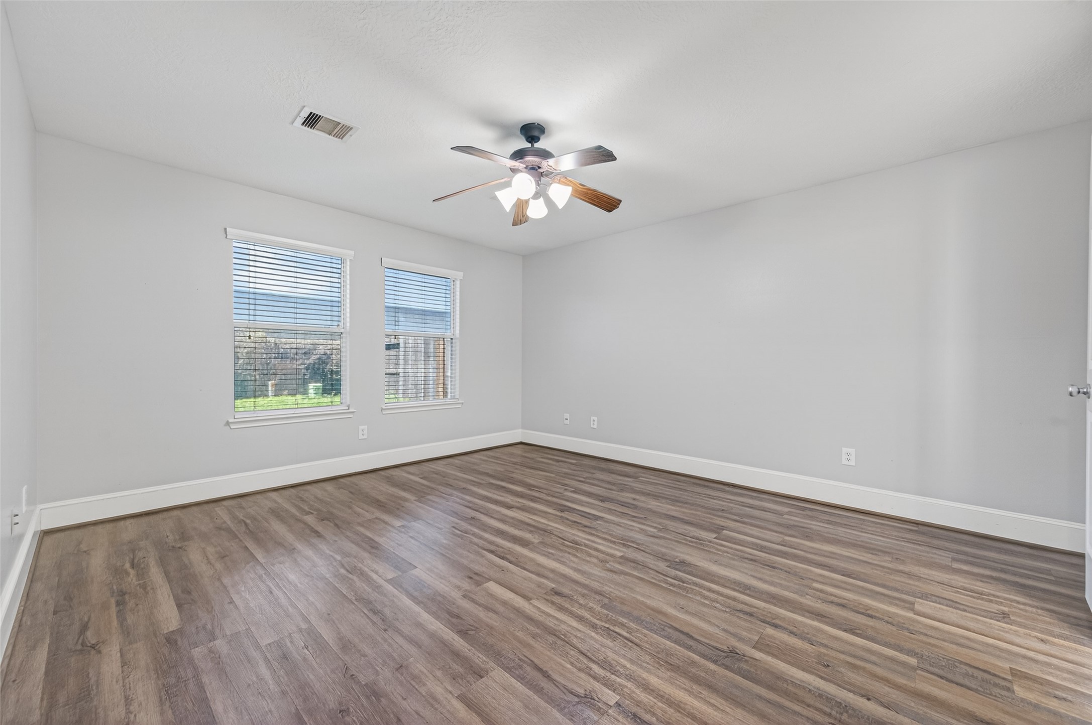 22419 Bridgestone Ridge Drive Spring, TX 77389 - Photo 20 of 48 a view of empty room with wooden floor and fan