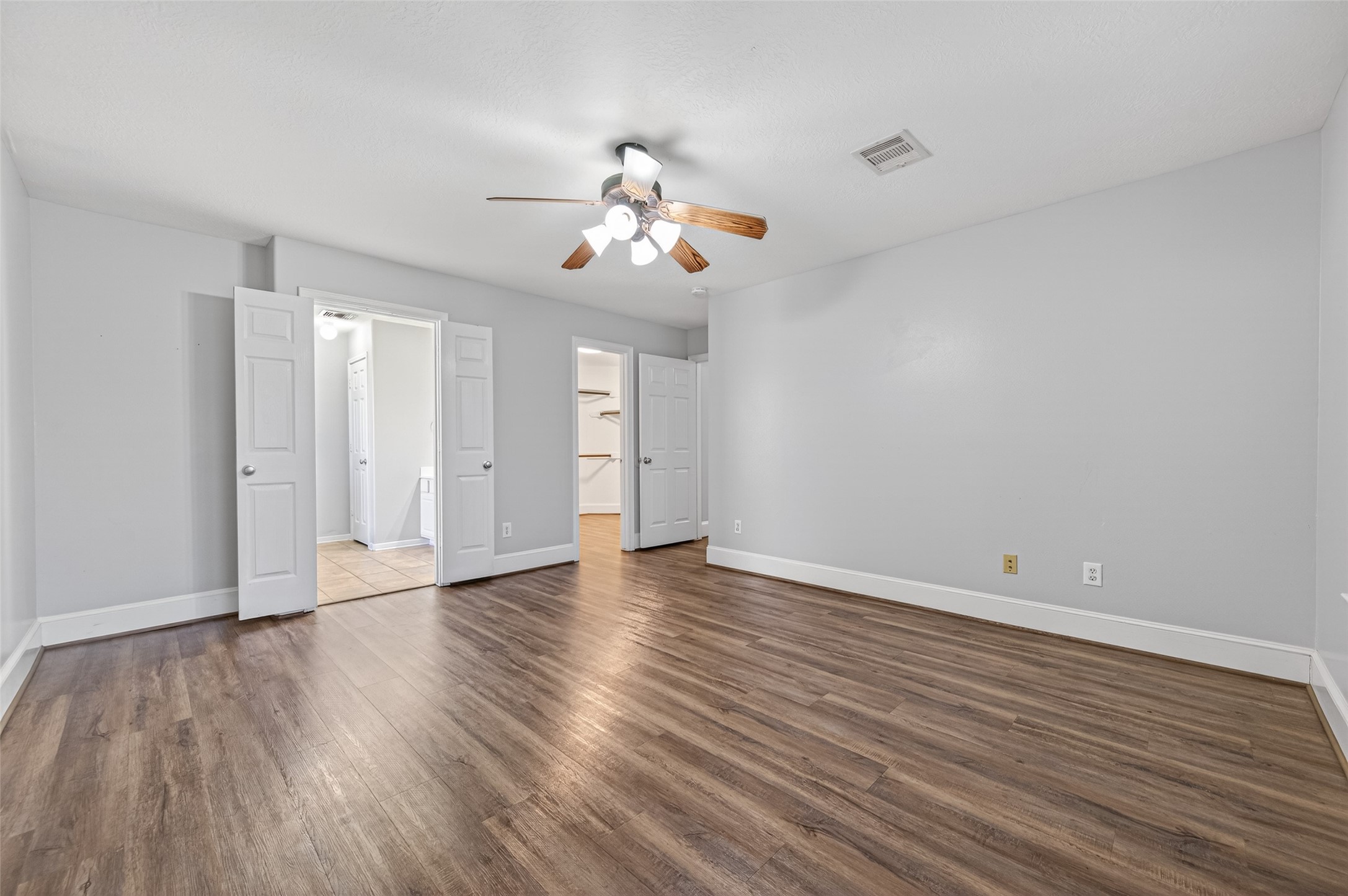 22419 Bridgestone Ridge Drive Spring, TX 77389 - Photo 22 of 48 a view of an empty room with wooden floor and a ceiling fan