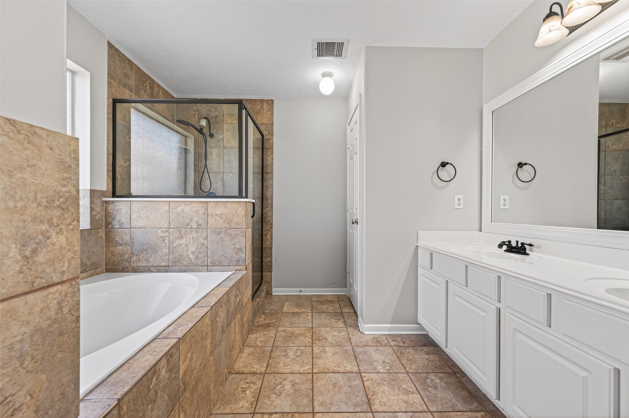 22419 Bridgestone Ridge Drive Spring, TX 77389 - Photo 23 of 48 a spacious bathroom with a tub sink and mirror