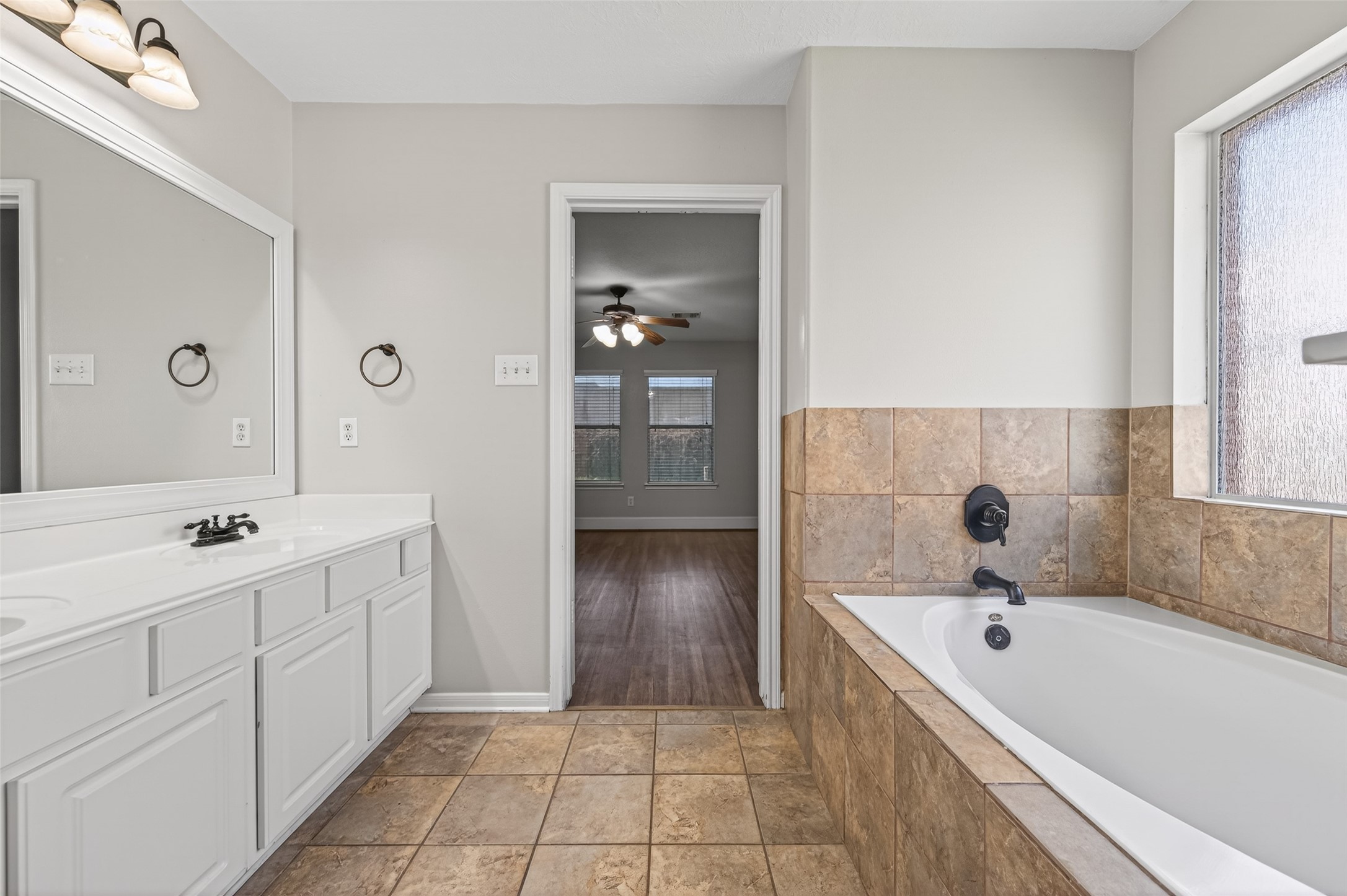22419 Bridgestone Ridge Drive Spring, TX 77389 - Photo 24 of 48 a bathroom with a tub sink and mirror