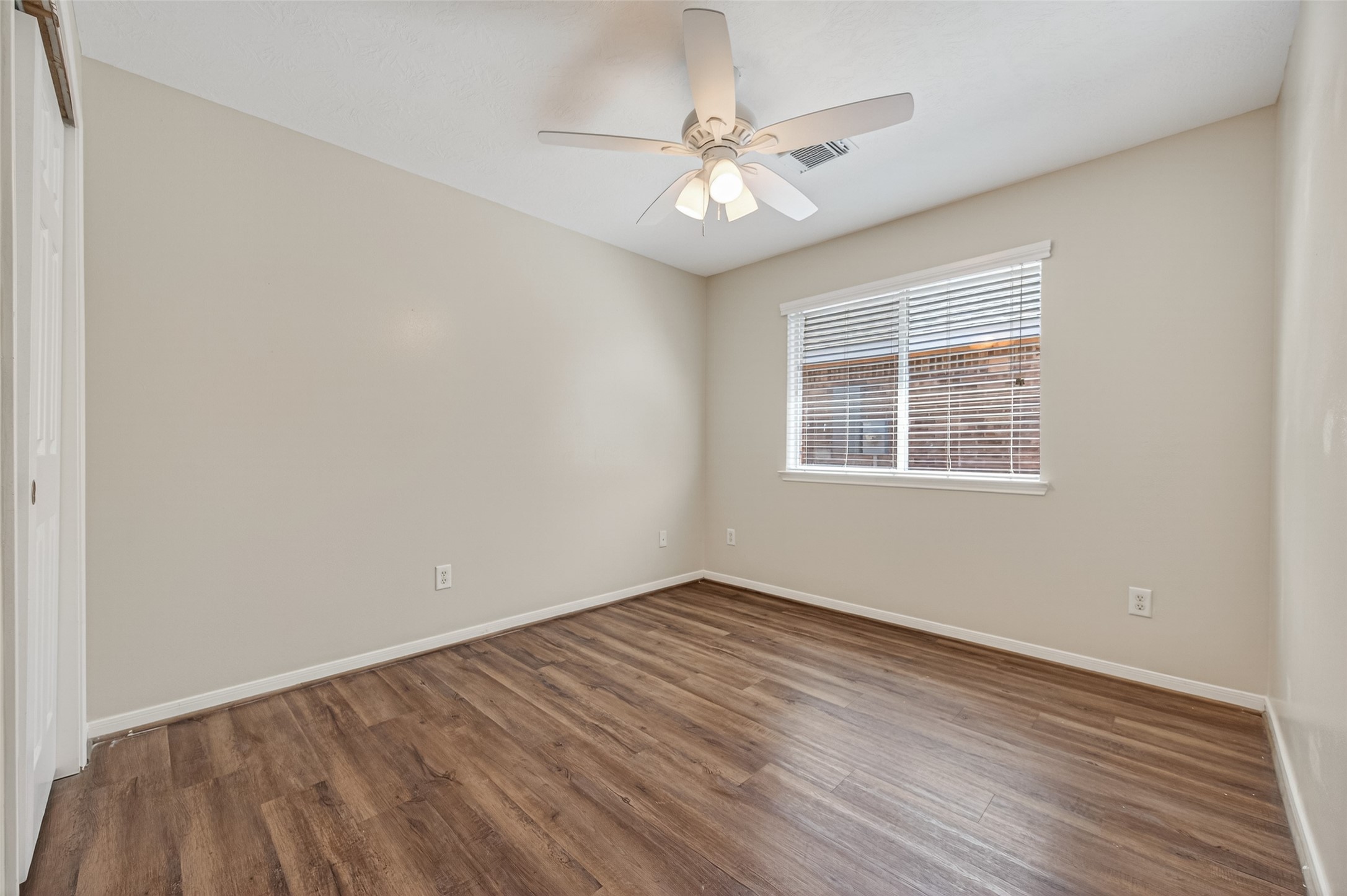 22419 Bridgestone Ridge Drive Spring, TX 77389 - Photo 30 of 48 a view of an empty room with wooden floor and a window