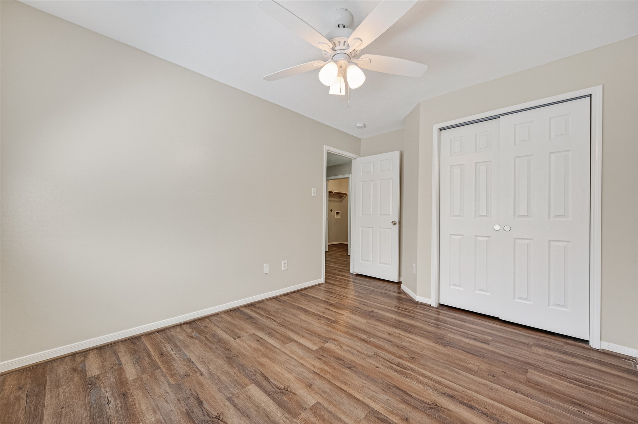 22419 Bridgestone Ridge Drive Spring, TX 77389 - Photo 31 of 48 an empty room with wooden floor and ceiling fan
