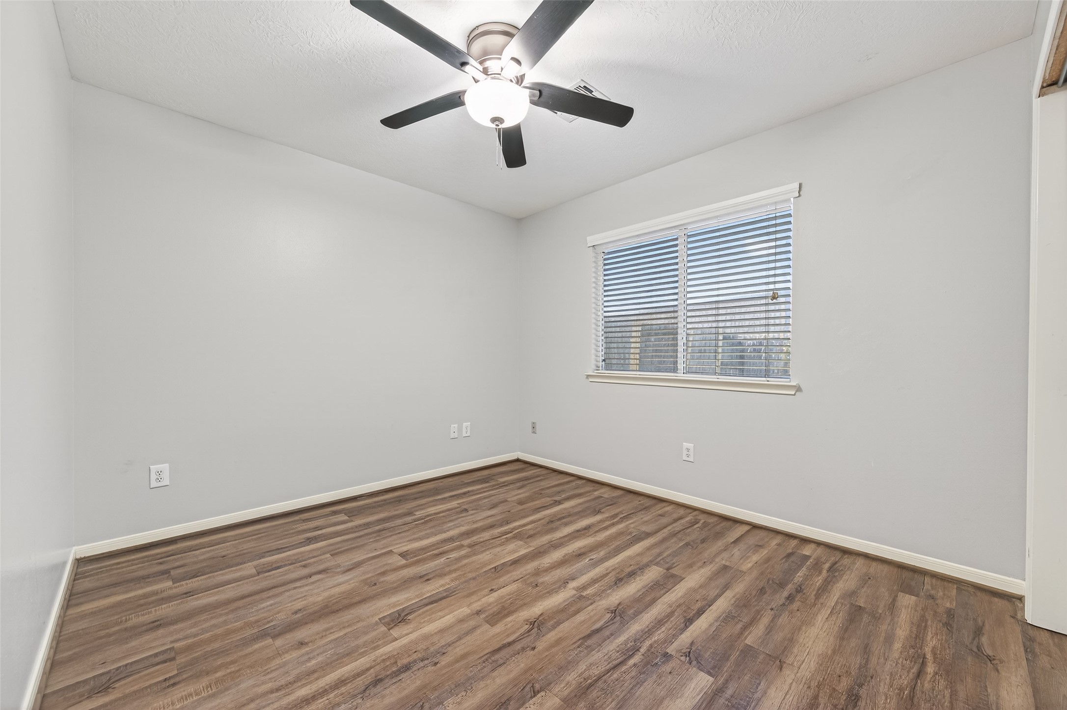 22419 Bridgestone Ridge Drive Spring, TX 77389 - Photo 32 of 48 a view of empty room with wooden floor and fan