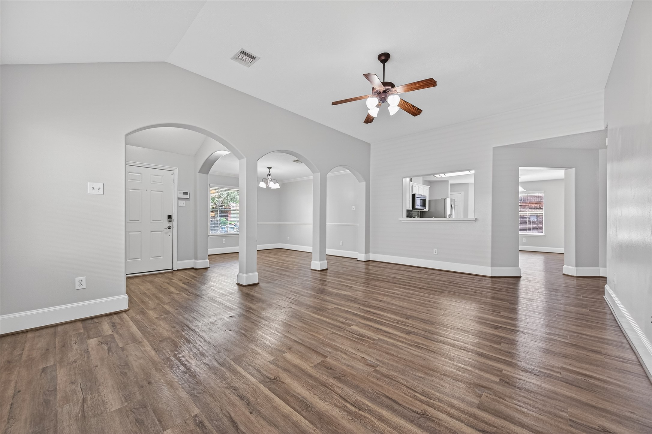 22419 Bridgestone Ridge Drive Spring, TX 77389 - Photo 7 of 48 a view of an empty room with wooden floor and a ceiling fan