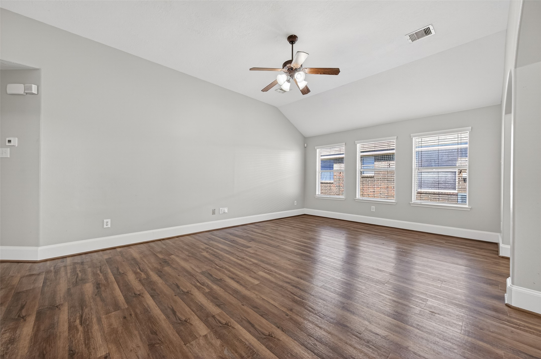 22419 Bridgestone Ridge Drive Spring, TX 77389 - Photo 8 of 48 a view of an empty room with wooden floor and a window